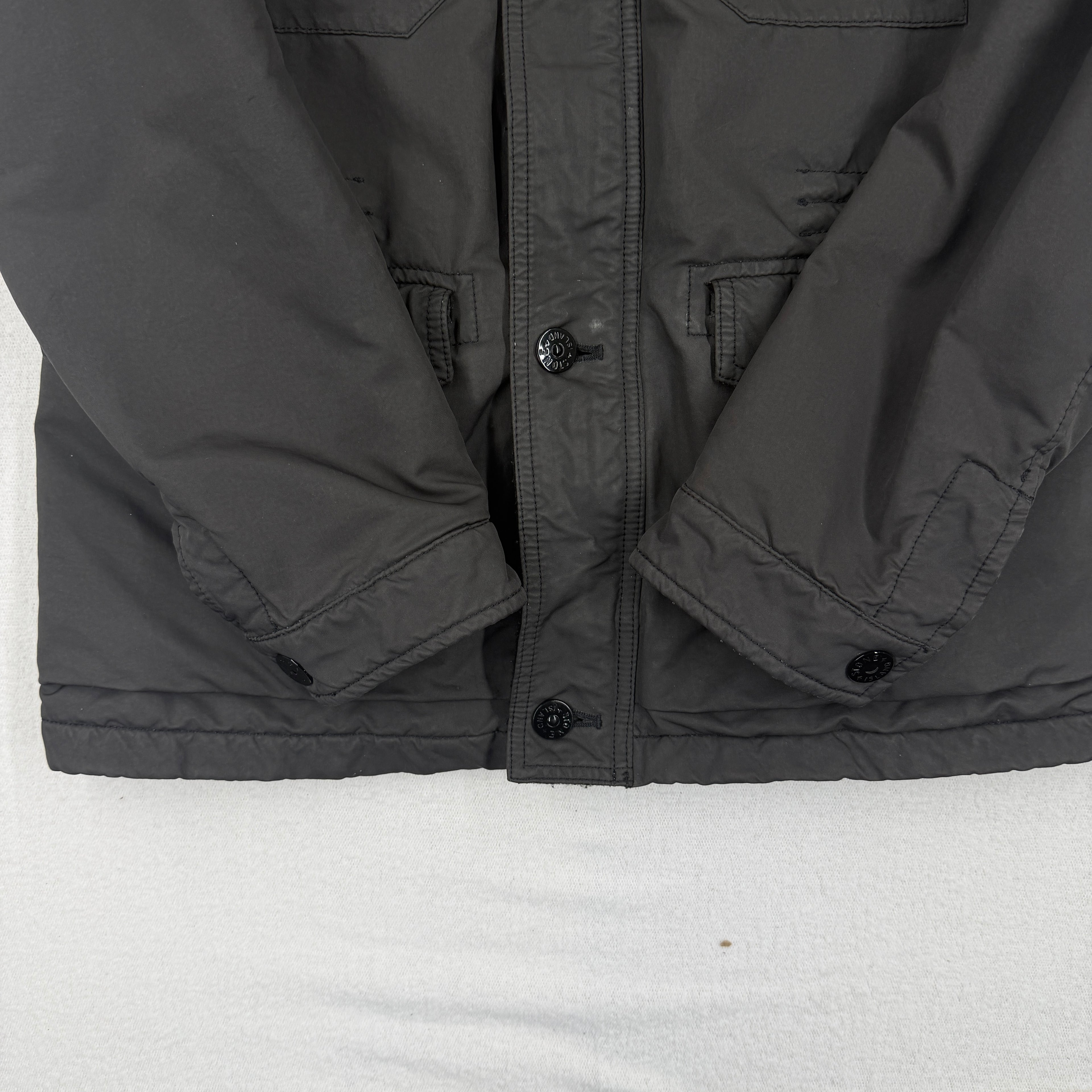 Front detail — hem and button stamp